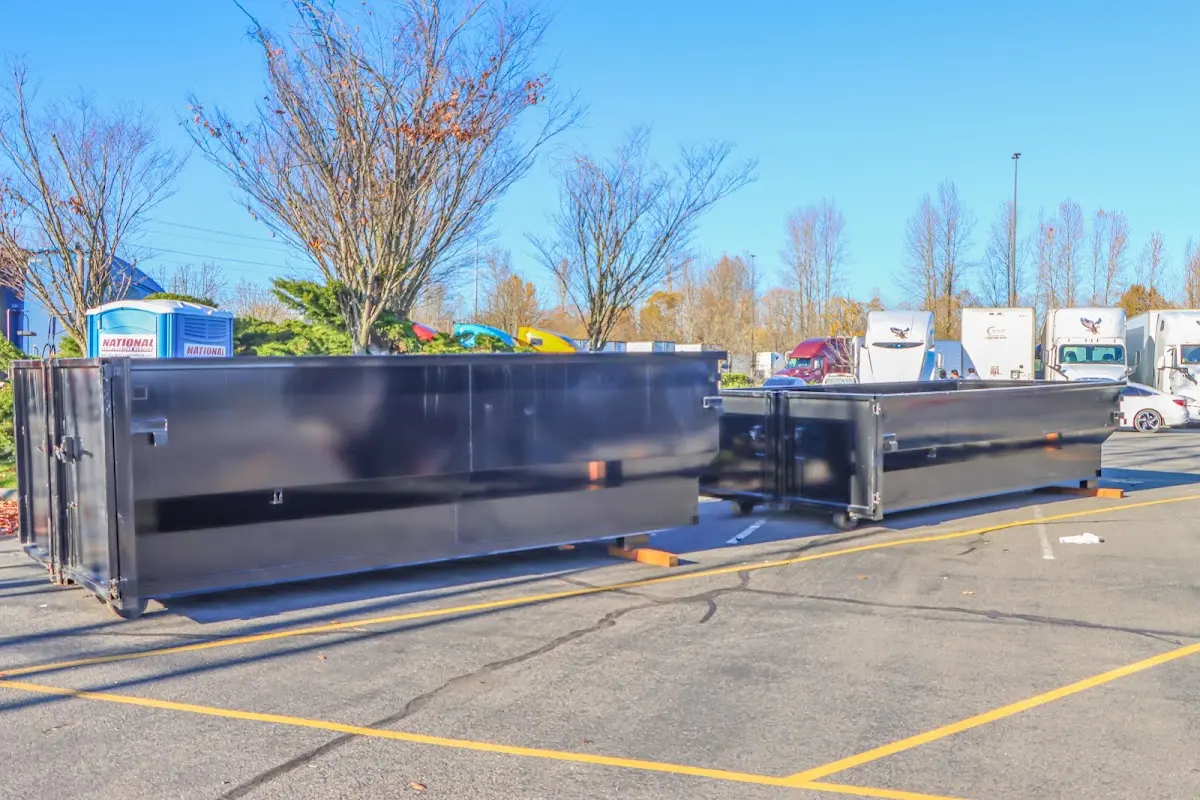 Professional dumpster rental service with roll-off container on residential driveway in Marshalltown